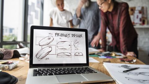 Laptop mit der Aufschrift Produktdesign steht geöffnet in einer Agentur. Laptop mit der Aufschrift Produktdesign steht geöffnet in einer Agentur.