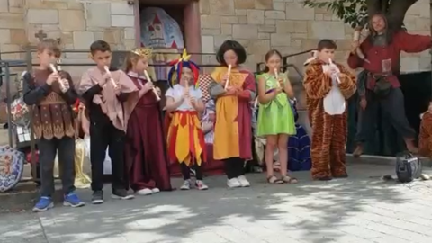 Kostümierte Kinder spielen Flöte