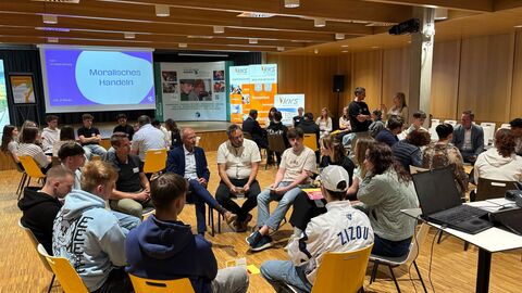 Bildungsminister Schwarz tauscht sich in Wetzlar mit ca. 100 Schülerinnen und Schülern aus  Bildungsminister Schwarz sitzt mit Schülerinnen und Schülern in einem Stuhlkreis