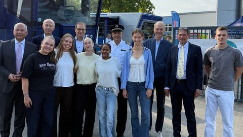 Enkelhelden Mehrere Erwachsene sowie Schülerinnen und Schüler stehen vor Polizei-LKW